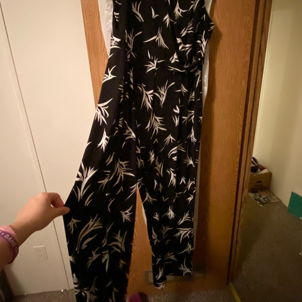 Black romper with white design. Has flares at the bottom.